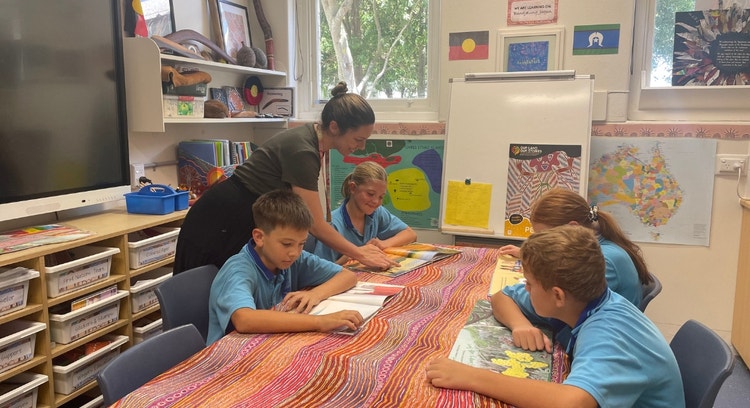 Our Aboriginal Education Coordinator supporting 4 students with reading in her Jarjum room
